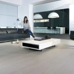 Woman Sitting On The Side Of The Sofa - Laminate Flooring Solutions - Woodland Lifestyle